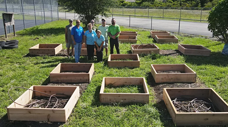 Owen-Ames-Kimball donates garden boxes, tables, benches and soil to Harns Marsh Elementary